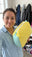 A woman holding the CocoonWeave™ in her laundry room